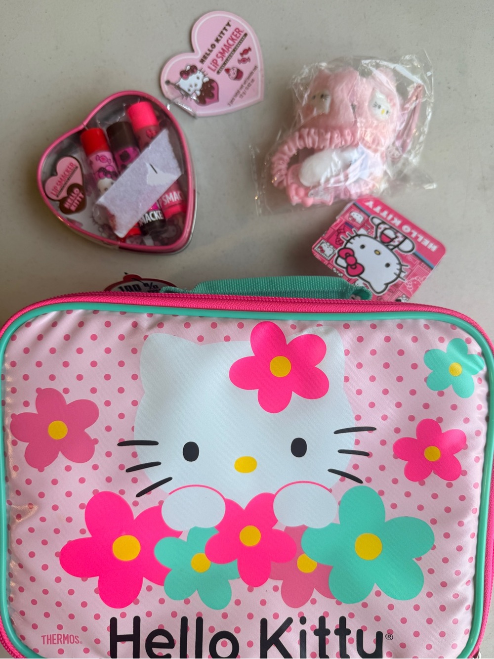 Hello Kitty lunchbox, hair accessories, and chapstick. All new.